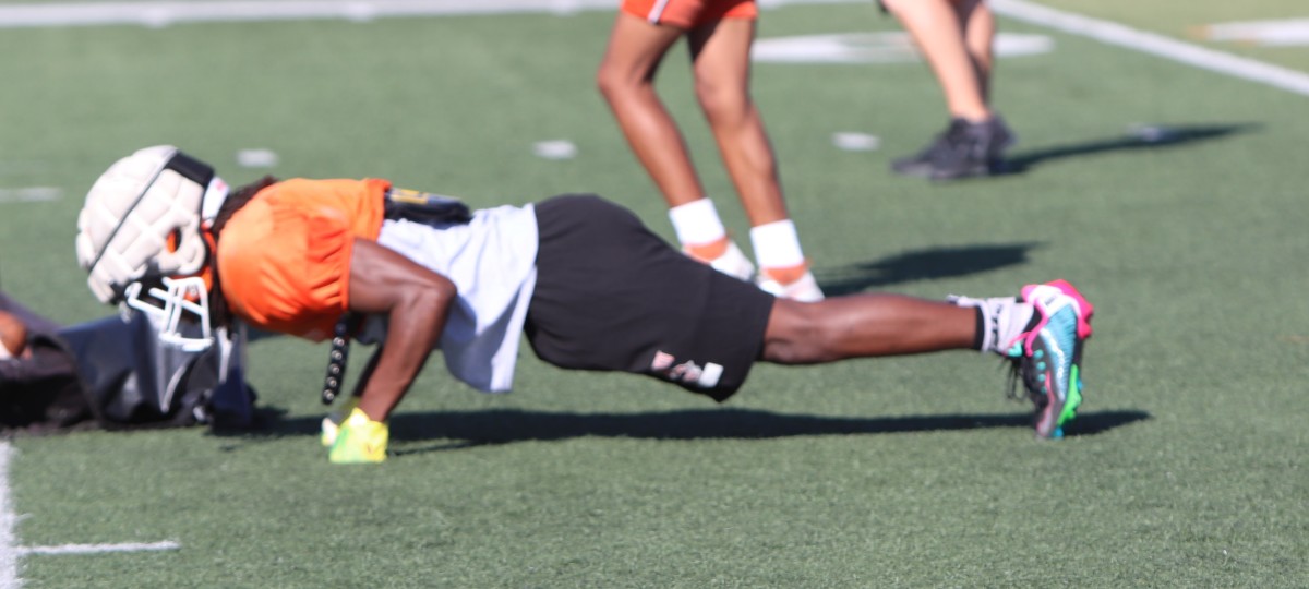 Dillon Greshman does some self-imposed pushups for dropping a pass during practice. Photo: John Murphy.